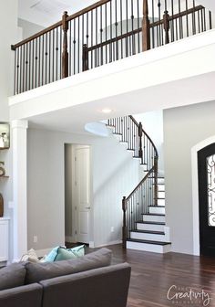 a living room filled with furniture and a stair case