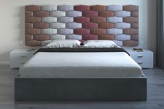 a bed with a headboard made out of different colored blocks on the wall behind it