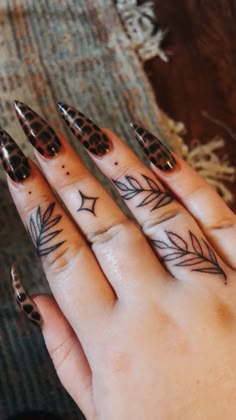 a woman's hand with some tattoos on it