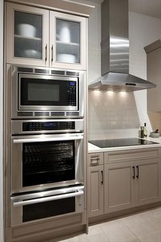 an image of a kitchen setting with ovens and cabinets in the middle of it