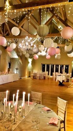 an image of a wedding venue with balloons and candles hanging from the ceiling, on instagram