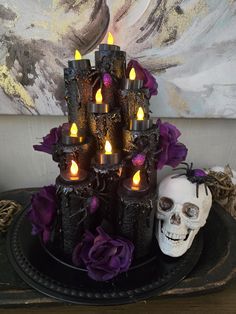 there is a cake with candles on it and a skull in the middle next to it