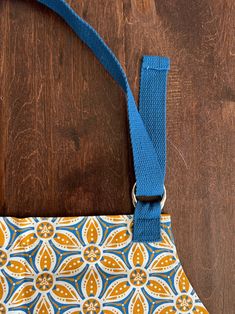 an orange and blue purse sitting on top of a wooden table