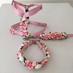 three pieces of pink and white flowered collars, leashes and bracelets