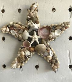 a starfish made out of seashells on a wall