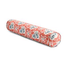 an orange and blue floral print pillow on a white background, with the top rolled up