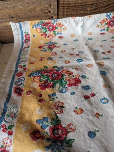 an old table cloth with flowers on it