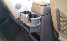 the interior of a car with cups in it