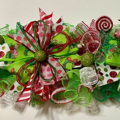 a green and red christmas wreath with candy canes