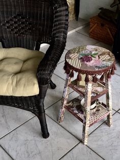 two wicker chairs sitting next to each other on a tile floor in front of a fireplace