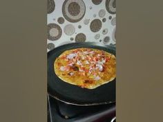 a pizza sitting on top of a black pan