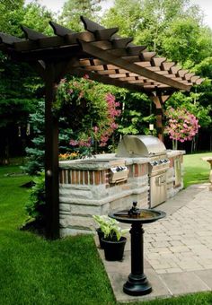 an outdoor bbq and grill area in the backyard