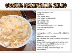 an orange creamsice salad in a white bowl on top of a wooden table