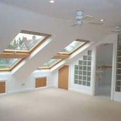 an empty room with two skylights in it