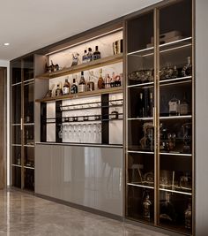 a bar with lots of liquor bottles and glasses on the shelves in front of it