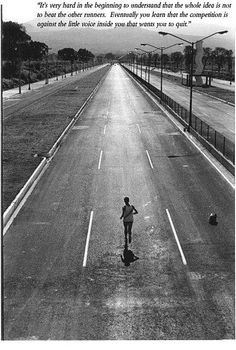 a black and white photo of a person running down the road with an inspirational quote on it