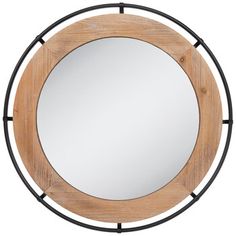 a round wooden mirror with metal frame