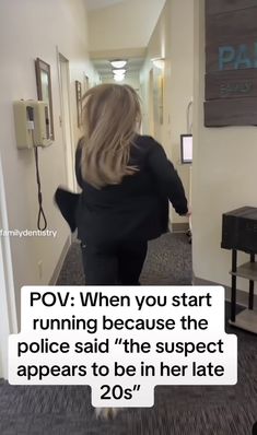 a woman walking down a hallway with a sign above her head that says pov when you start running because the police said'the suspect appears to be in her late 20s