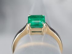 The mounting of this ring is vintage, crafted of a perfect, 18 karat yellow gold. We've set it with a gorgeous emerald that looks amazing surrounded by the bright polish of the prongs! Shades of green simply gleam from this gorgeous ring!Metal: 18K Yellow Gold Gem: Emerald 1.295 CaratsGem Measurements: 6.9 x 6.3 mm, Emerald Cut Ring Size: 6.50Marks: “18K” Stamped on the inside band Asscher Cut Emerald Ring In 14k Gold, Green Asscher Cut Emerald Ring In 14k Gold, Timeless Asscher Cut Green Emerald Ring, Classic Gia Certified Emerald Ring, Classic Emerald Rings With Princess Cut, Classic Emerald Rings Princess Cut, Princess Cut Emerald Ring In 14k Gold, Classic Emerald Ring Princess Cut, Classic Emerald Ring With Princess Cut