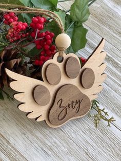 a wooden ornament with a dog's paw and name