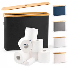 several different types of toilet paper in front of a gray box with wooden lid and handles