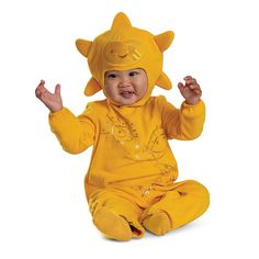 a baby in a yellow costume sitting on the ground with his hands up and eyes closed