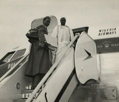 two men standing on the steps of an airplane