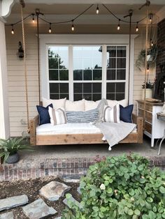 a porch swing bed with pillows on it