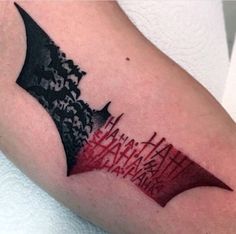 a batman tattoo on the arm with red ink and black lettering that reads, i am batman