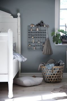 a bedroom with gray walls and white furniture