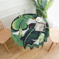 a table with a plant on it next to two chairs