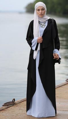 Introducing Annah Hariri's Exquisite Abaya Dress - a perfect blend of tradition and modern elegance in Blue & Black. Designed with impeccable craftsmanship, versatility, and adaptability, this dress celebrates the beauty and grace of the wearer. Available as a kimono abaya or elegantly designed eid abaya, it is a treasure in your wardrobe for any occasion. Experience unmatched elegance with Annah Hariri. HN022 Islamic Clothing Women, Annah Hariri, Eid Abaya, Abaya Dresses, Pink Heart Dress, Black Elegance, Abaya Kimono, Black Cape, Cherry Dress