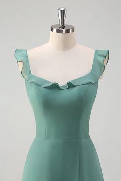 a dress on a mannequin with a white dummy behind it and a light green top