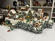 a christmas village is displayed on a table