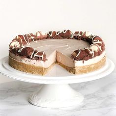 a chocolate cheesecake on a white cake plate