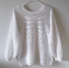 a white sweater hanging on a wall