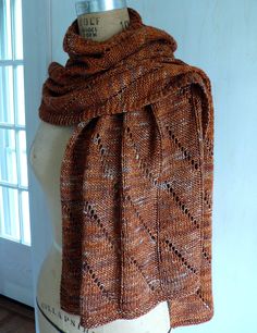 a mannequin wearing a brown knitted scarf