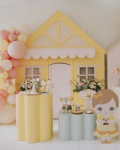 a doll house with balloons and decorations on the floor next to two small stools