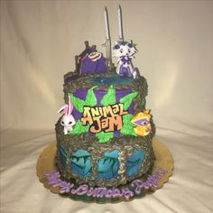 a birthday cake decorated with cartoon characters on it