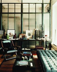 a living room filled with furniture and lots of windows