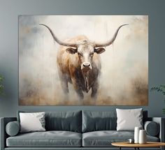 a living room with a couch, table and painting on the wall above it that has a cow's head