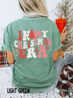 These Comfort Colors In My Christmas Era tees are sure to get you in the holiday spirit! They're comfy, cozy, and OH SO CUTE!  Would make a fabulous gift for anyone on your list, and would be a hit at holiday parties!  Wear it baking cookies and watching Christmas movies or head out shopping, tree picking, or to see Christmas lights!  No matter where the holiday season takes you, you'll love it!  Thanks for stopping by! Shirts are Adult Unisex sizing and they are soft and cozy Rolled Sleeves in pictures are for styling purposes only Props used in photos and NOT included with purchase SIZING These are Unisex Sized T-shirts. UNISEX T-SHIRTS - Women typically wear one size down Models are wearing 1 or 2 sizes up, please order 1 or 2 sizes up if you would like an oversized look Please refer to Christmas Shirt Outfit Women, Simple Christmas Shirts, In My Christmas Era, Christmas Tshirts Designs, Christmas Graphic Tee, Christmas T Shirt Ideas, Christmas Tshirt Ideas, Christmas Shopping Shirts, Holiday Treats Gifts