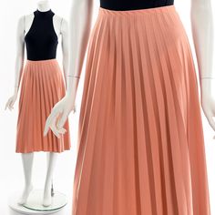 "- 60s/70s peach pleated skirt - elastic waist - knee length Fits like:  M - L Material:  Polyester Condition:  Great Clipped on Mannequin: Yes ✂ SIZE + FIT ✂ Length: 29\" / 74 cm Waist: 28\" to 34\" / 71 cm to 86 cm Hips: 46\" / 117 cm All measurements are taken with garment lying flat. ALWAYS refer to measurements as vintage sizes can vary greatly from today's modern sizes. We recommend comparing measurements above with a similar style garment you own for best fit before purchasing.  DRESS FORM / MANNEQUIN is wearing the size detailed above but she typically measures a size 4/6 by modern retail sizes or a general size small. Belt Accessories and other clothes are NOT included. ▲▲All Garments Have Been Laundered/Steamed or Dry Cleaned and are Ready-To-Wear▲▲ Are you interested in purchasi Orange Pleated Party Skirt, Orange Pleated Skirt For Party, Vintage Knee-length Pleated Spring Skirt, Orange Pleated Skirt For Spring, Chic Fitted Peach Skirt, Spring Orange Pleated Skirt, Peach Skirt, Dress Form Mannequin, Small Belt