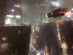 a sci - fi city at night in the rain