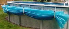 an above ground swimming pool with blue tarp