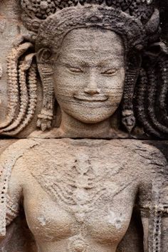 the face and head of a stone statue