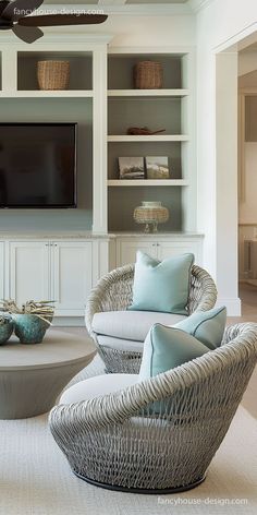 a living room filled with furniture and a flat screen tv mounted to the side of a wall