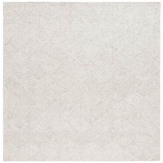 a white rug with diamond shapes on it