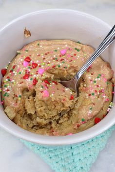 a white bowl filled with cake batter and sprinkles