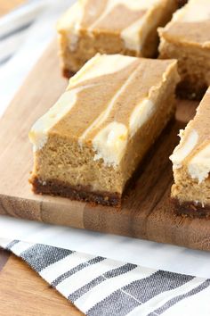 several pieces of cake sitting on top of a wooden cutting board